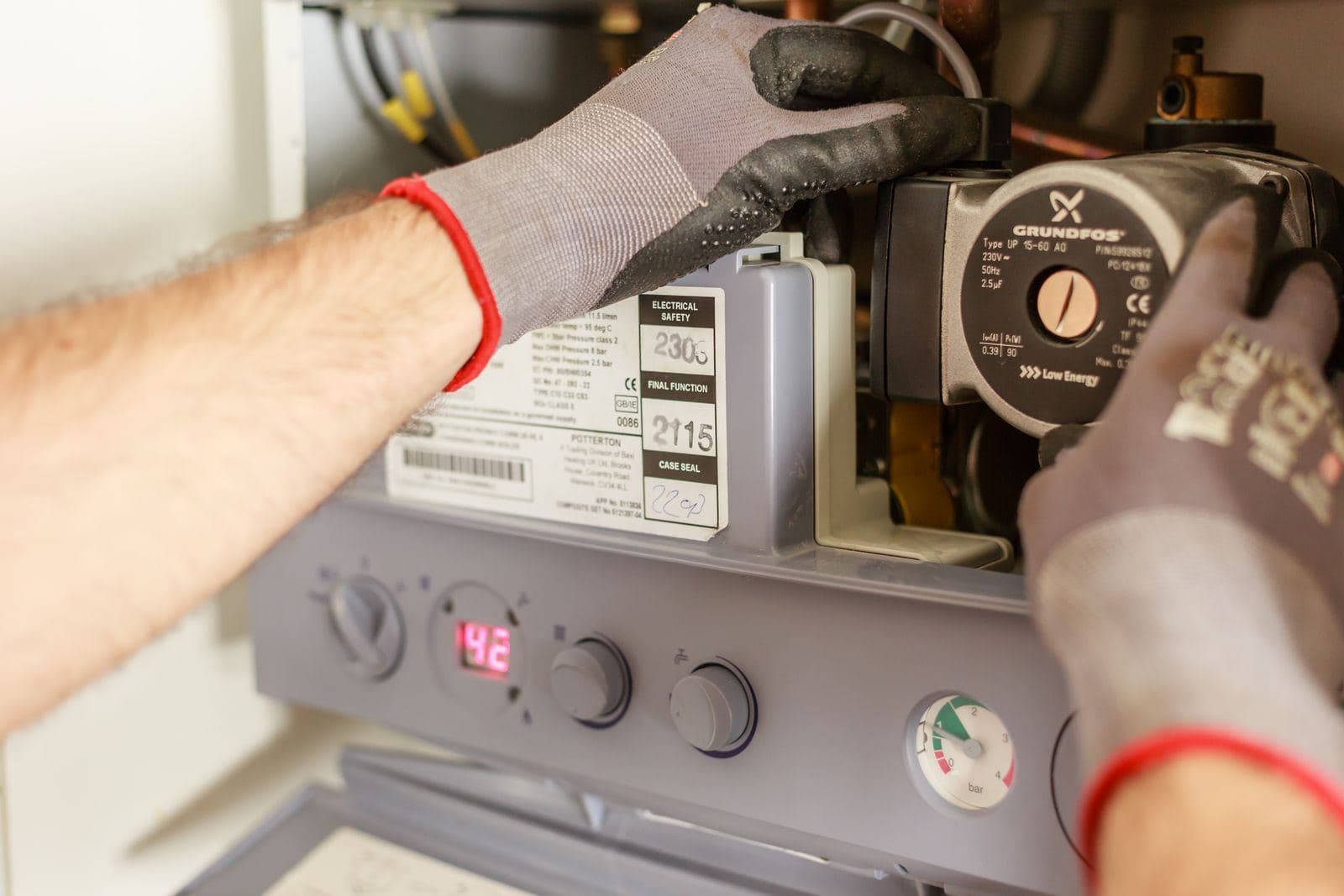 Technician servicing a heating system control board
